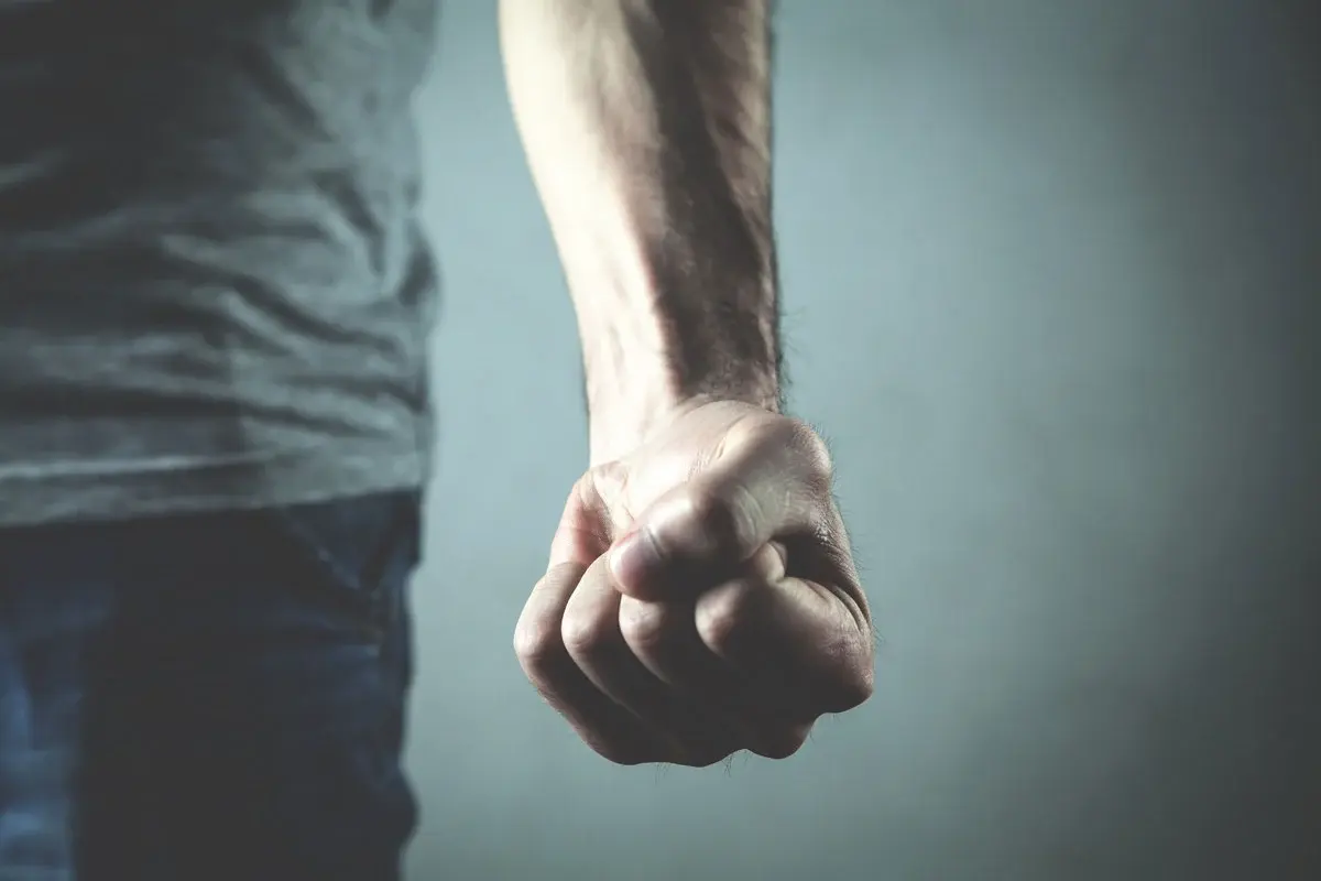 A man's hand in a clenched fist.