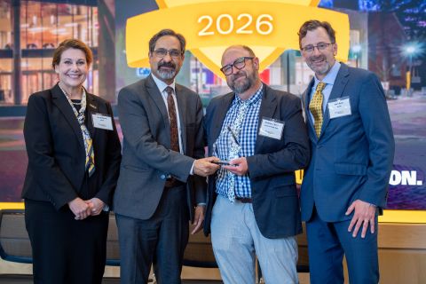 Andrew J. Barnes receiving an award, standing with the vice president for research development, vice president for research, and the associate vice president for research at the 2026 ARIA event.