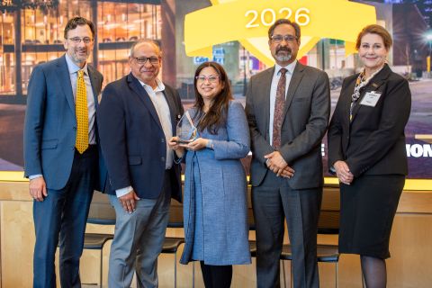 Radhika Barua receiving an award, standing with the vice president for research development, vice president for research, the provost, and the associate vice president for research at the 2026 ARIA event.