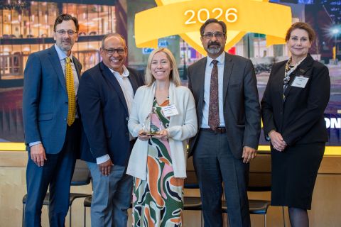 Ann F. Haynos receiving an award, standing with the vice president for research development, vice president for research, the provost, and the associate vice president for research at the 2026 ARIA event.