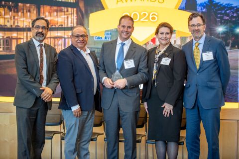 Jonathan E. Isaacs receiving an award, standing with the vice president for research development, vice president for research, the provost, and the associate vice president for research at the 2026 ARIA event.